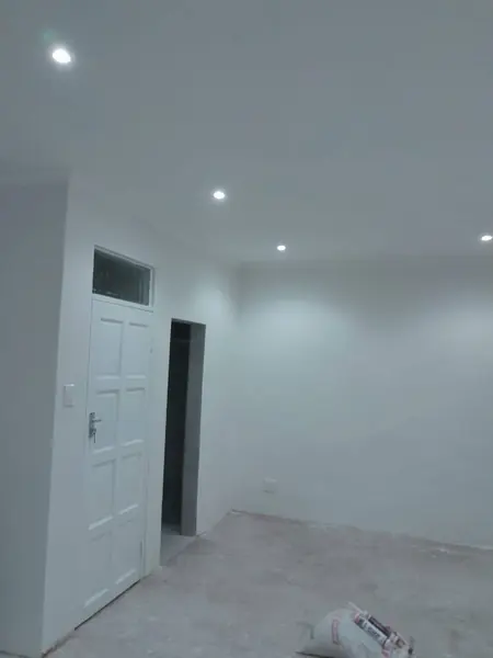 Painting job: white painted room with spotlights, door, bag of sealant