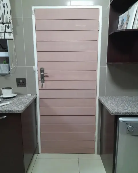 Before. Painting job: pink-beige slatted kitchen door, closed, before painting