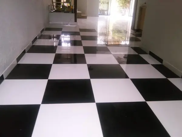 Renovations job: glossy black and white chequered tile floor in hallway