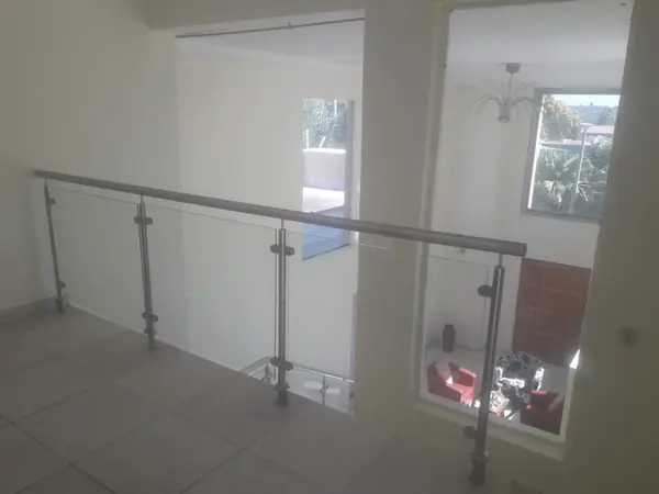 Renovations job: glass and steel balustrade on landing overlooking hall