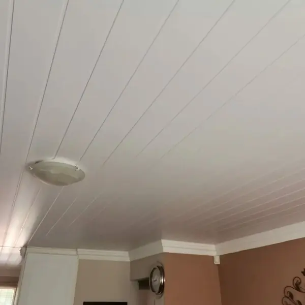 Renovations job: white panelled ceiling with light fitting and cornice