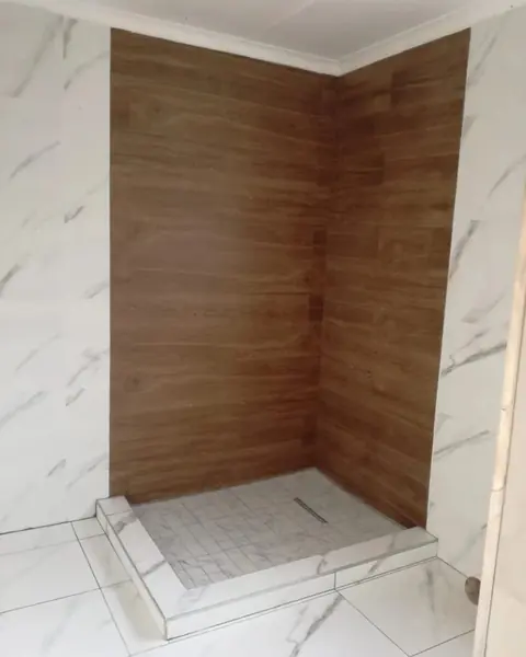 Renovations job: tiled shower corner, wood-look and marble-look tiles