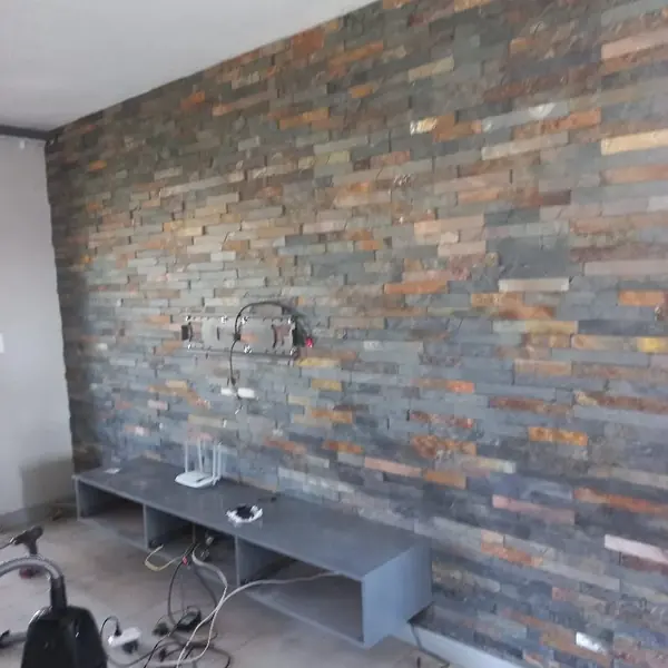 Renovations job: stone cladded wall, cables and TV unit, near finished