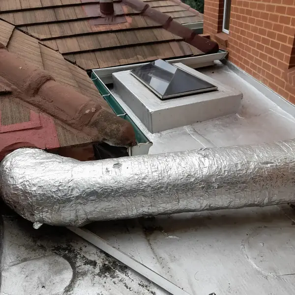 Waterproofing job: sealed flat roof edge with skylight, foil duct, tiled roof